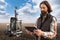 Farmer controls autonomous robot for measuring soil quality in an agricultural field.