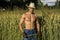 farmer or cowboy next to hay field