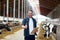 Farmer with cows showing thumbs up on dairy farm