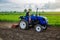 A farmer is cultivating a farm field. Milling soil, crushing before cutting rows. Farming, agriculture. Loosening surface, land