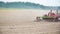 Farmer cultivating field. Close up view