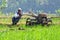 A FARMER cultivating a field with a modern plow before the planting season arrives in the rice fields around Rawa Pening