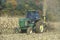 Farmer cutting corn with tractor