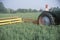 Farmer cutting hay field