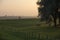 A farmer cycling during sunset