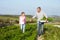 Farmer With Daughter Harvesting Organic Carrot Crop On Farm