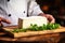 A farmer demonstrates a piece of cheese he made with his own hands. Homemade cheese production on a farm. Natural product. Close-