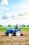 The farmer drives a tractor with a milling unit equipment. Loosening land cultivation Use of agricultural machinery to speed up