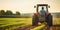 A farmer driving a tractor in a field in springtime