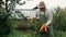 farmer, an elderly man , is holding a biological organic carrot product.