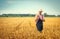 Farmer examine wheat plant in field