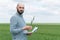 Farmer examines the field of cereals. Agronomist or farmer examines the growth of wheat