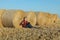 Farmer examining wheat field after harvest using tablet