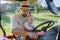 Farmer father riding tractor with his little baby son.