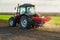 Farmer fertilizing arable land with nitrogen, phosphorus, potassium fertilizer