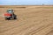 Farmer fertilizing soybean residues field