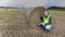 Farmer on field checking the straw bale