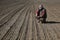 Farmer in field after sowing analyze land