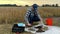 Farmer filling sample bag with soil, preparing material for analysis