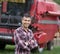 Farmer in front of combine harvester