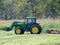 Farmer with Frontloader and Bush-Hog on his Tractor