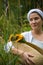 Farmer Girl with Basket with corn cobs on green , bread, pumpkin and flowers.