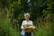 Farmer Girl with Basket with corn cobs on green , bread, pumpkin and flowers.