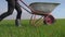 Farmer girl red neck works in the field lifestyle with a garden trolley in rubber boots. farmer eco farming farming