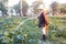 Farmer giving fertilizer and water to pumpkin.