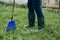 Farmer in green rubber boots  legs in a close-up.