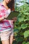 Farmer in greenhouse checking cucumber plants