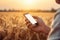 farmer hand hold mobile on agricultural field