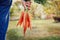 Farmer hand holding a bunch of fresh organic carrots in autumn garden outdoor