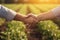 farmer handshake on agricultural field