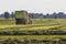 Farmer harvesting hay from a meadow