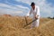 Farmer harvesting wheat with scythe