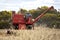 A farmer harvests a broadacre paddock of wheat.