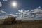 A farmer harvests a broadacre paddock of wheat.