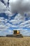 A farmer harvests a broadacre paddock of wheat.