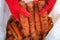 A farmer harvests a crop of carrots in a polypropylene sack.