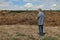 Farmer and heap of dung in field