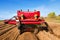 farmer with his tractor and trailer to pick up stones in the fields