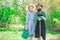 A farmer and his wife standing in their field. Crop planting at fields. Farmars couple enjoy spring nature and take care