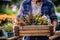 A farmer holding a crate of colorful flowers at a local farmers\\\' market.