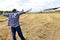 Farmer holding a fork and looking on his field