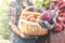 Farmer holding fresh cabbage with a blurred back of women holding a basket of vegetables