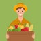 The farmer holds a box of vegetables. Autumn harvest