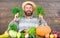 Farmer with homegrown vegetables harvest. Excellent quality harvest. Man with beard proud of his harvest wooden