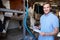 Farmer Inspecting Cattle During Milking