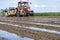 Farmer Installing Drip Tape Irrigation Under Plastic Mulch on a Vegetable Bed